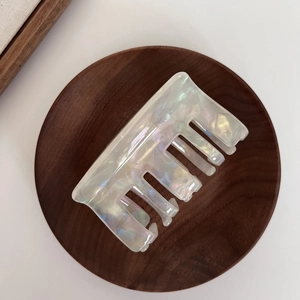 Macro shot of square acetate hair claw clip with iridescent pearlescent finish