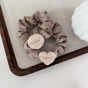 Elegant champagne satin scrunchies set with Lucky heart and round bead pendants