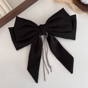 Elegant black satin bow hair clip featuring luxury rhinestone tassels for formal styling