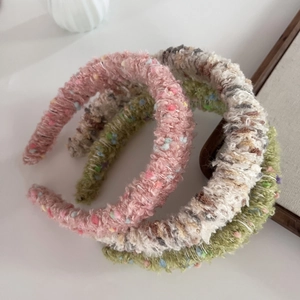 Set of colorful knitted candy dot headbands in soft pink green and beige plush textures