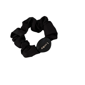 Black satin scrunchie with a gold Lucky letter button on a white background