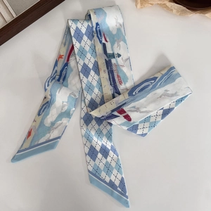 Detail of oil painting style silk scarf showing lighthouse patterns and blue checkered design