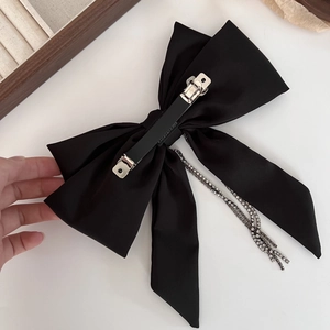 Elegant black satin bow hair clip with sparkling rhinestone tassels and silver spring clip