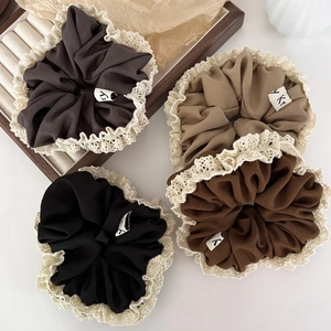 Set of four lace-trimmed scrunchies in neutral tones of grey, brown, and beige