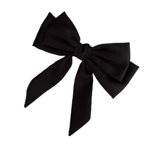 Elegant black satin oversized bow hair clip with long ribbons on a white background