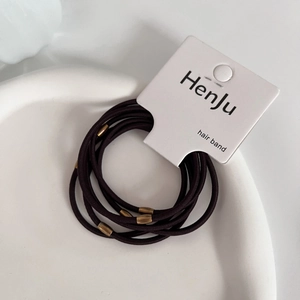 Detail of durable brown elastic hair bands featuring elegant bronze metal beads