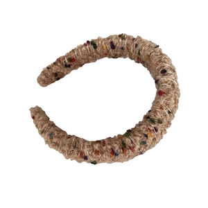 Chunky light brown knitted headband with colorful candy dot accents and soft plush texture