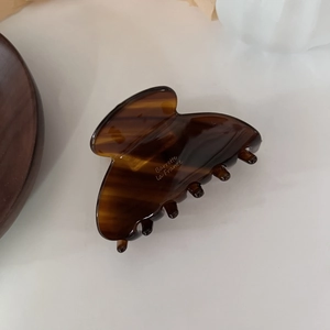 French tortoiseshell acetate hair claw clip for elegant half-up hairstyles on white background