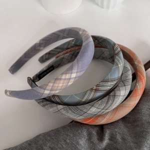 Set of four plaid sponge headbands in blue, grey, and orange soft fabric textures