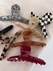 Collection of large acetate hair claws in various patterns like leopard and checkerboard