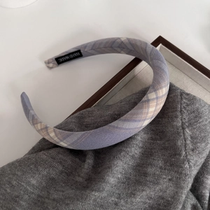 Detail of purple plaid padded headband with a hand made label on the inner fabric