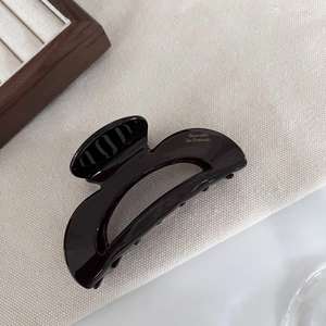 Detail view of deep brown acetate hair claw with Barrette La France lettering logo