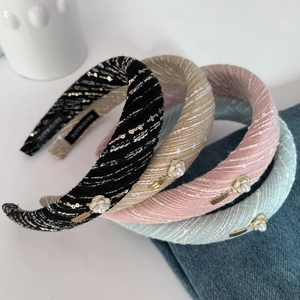Detail of tweed headbands with faux pearls, sequins and golden LOVE DAYS metal plates