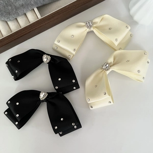 Detailed macro view of heart-shaped diamond on elegant bow hair clip for women
