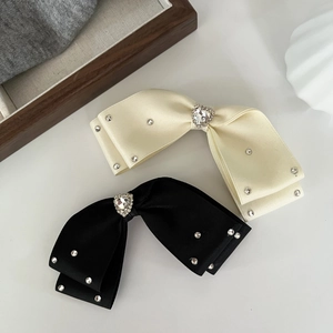Elegant satin bow hair clips with heart rhinestones in black and off-white colors