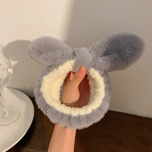 Close-up of soft plush bunny ear headband in grey-blue with elastic thick velvet texture