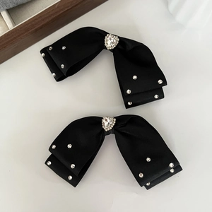Elegant set of two black fabric bow hair clips with crystal heart and small rhinestones