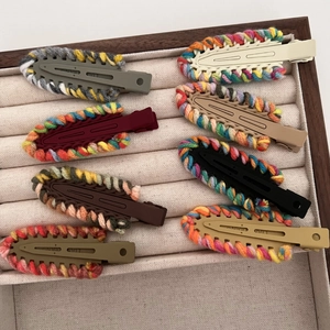 Detail of 7-piece set knitted yarn hair clips showing colorful textures and matte base