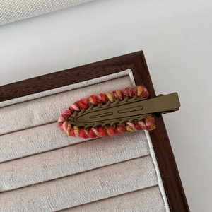 Detail view of ethnic hand-woven crochet trim on army green matte metal hair clip