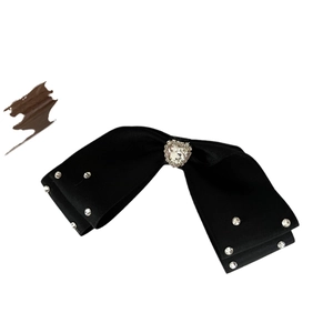 Elegant black bow hair clip featuring a large crystal heart centerpiece with rhinestones