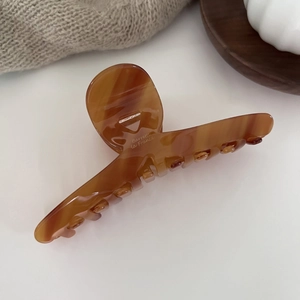 Detailed macro view of large amber tortoiseshell hair claw with Barrette la France text