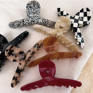 Chic acetate hair claws in various patterns including polka dot and marble finish
