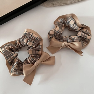 Elegant plaid bow scrunchies in warm coffee and champagne satin for hair styling