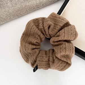 Deep brown knitted scrunchie with retro diamond pattern and elastic knit texture