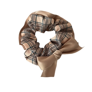Plaid and satin拼接 bow scrunchie in warm brown and beige for elegant hairstyling