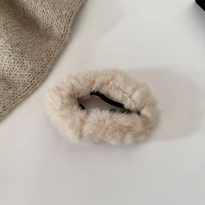 Close-up of soft plush cream faux fur hair tie with high-elastic black rubber band detail