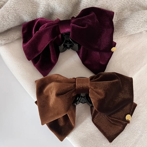 Elegant velvet bow hair claw clips in burgundy and brown with gold logo plate
