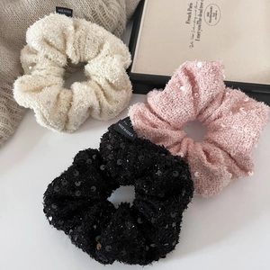 Three-piece set of sequin tweed scrunchies in cream, soft pink, and classic black tones