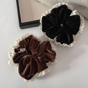 Detail of vintage velvet scrunchies in black and brown with delicate lace edges