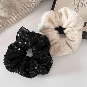 Sparkling black sequin and cream plush oversized scrunchies in minimalist style