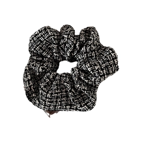Classic black and white houndstooth tweed scrunchie with elegant woven texture