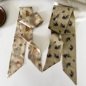 Detail of French vintage floral twilly scarves in brown and olive green silk textures
