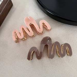 Elegant wavy acetate hair claw clips with gold metal base in pink and coffee brown