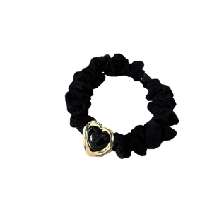 Elastic black scrunchie with a gold-rimmed heart charm on a clean white background