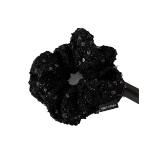 Elegant black sequin tweed scrunchie hair tie for women on a display stand
