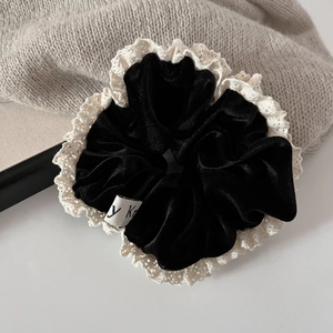 French vintage black velvet scrunchie with lace trim on grey knit background