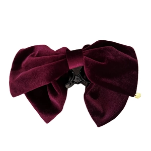 Elegant large burgundy velvet bow hair claw clip with golden metal tag detail