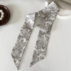 Detail of French vintage floral twilly scarf with rose patterns on silk fabric