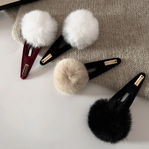 Chic winter pom pom hair clips set with gold handmade labels and velvet finish