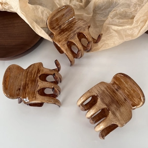 Three elegant oil-painting style wood grain hair claws in a retro French aesthetic