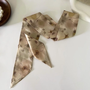 Detail of elegant French retro floral silk scarf with soft earthy tones and pointed ends