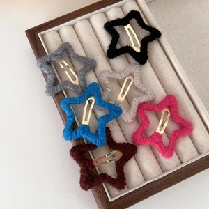 Lot de six barrettes étoiles en laine colorées dans un plateau à bijoux en velours