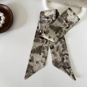 Detail view of a vintage French silk twilly scarf with abstract floral patterns