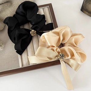 Chouchous élégants en satin noir et champagne avec détails de roses dorées raffinées