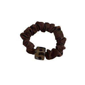 Deep coffee satin scrunchie with leopard print acrylic charm on white background