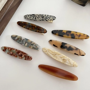 Detail view of 8 tortoise shell acetate hair clips with gold metal duckbill clasps